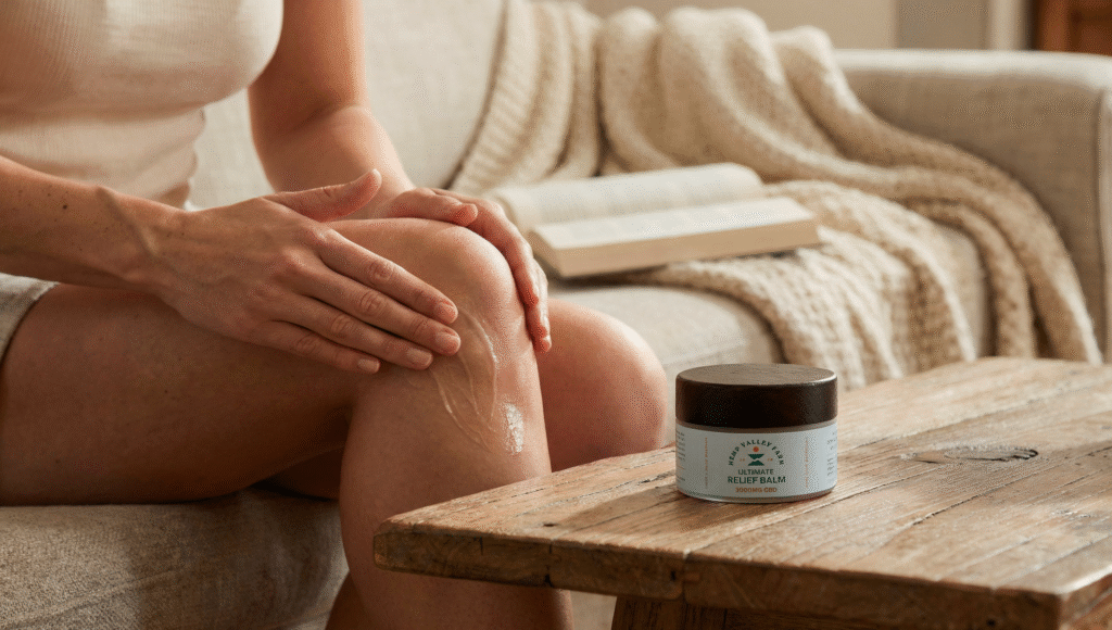 Woman applying full-spectrum CBD balm for natural joint and knee pain relief